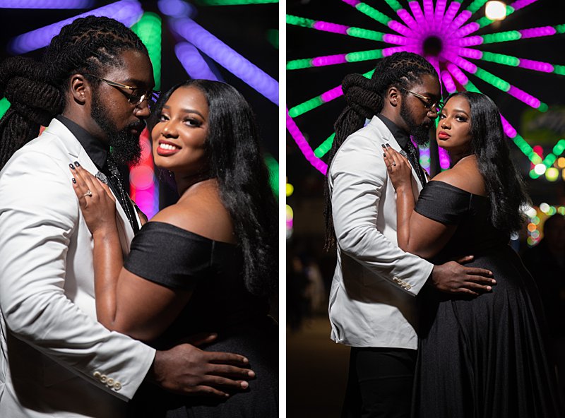 Black couple hugging in front of ferris wheel at nc state fair engagement session