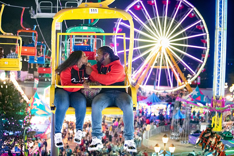 Black couple on ride at nc state fair engagement session