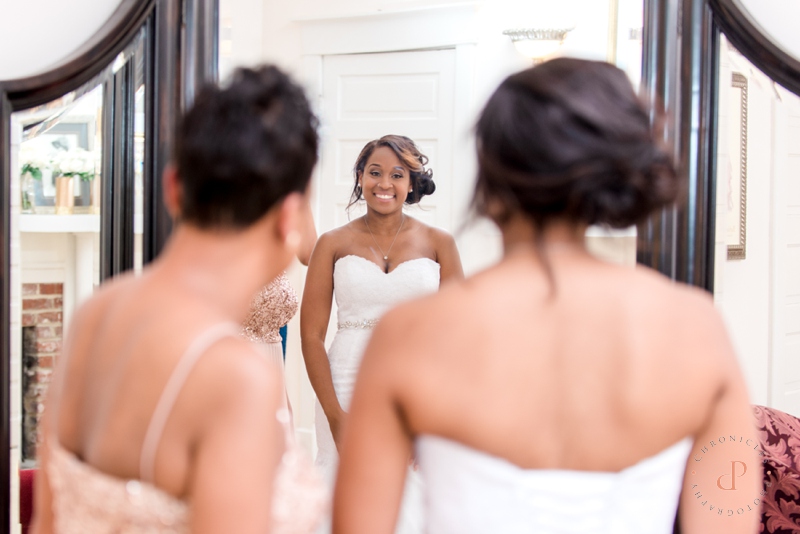 Bride Looking In Mirror with Mom | Chronicles Photography | www.chroniclesphotography.com