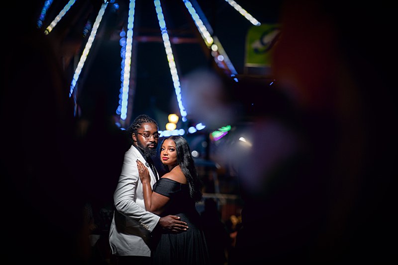 Black couple hugging at nc state fair engagement session